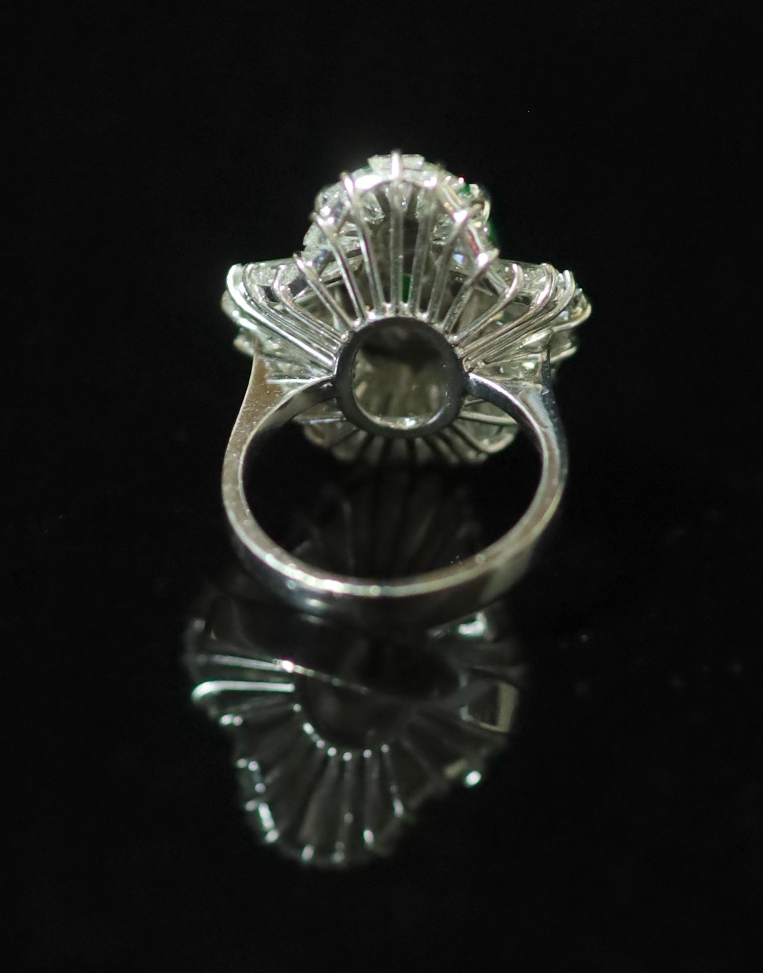 An 18k white gold, green jade and trapeze cut diamond shaped oval 'ballerina' ring, probably Chinese